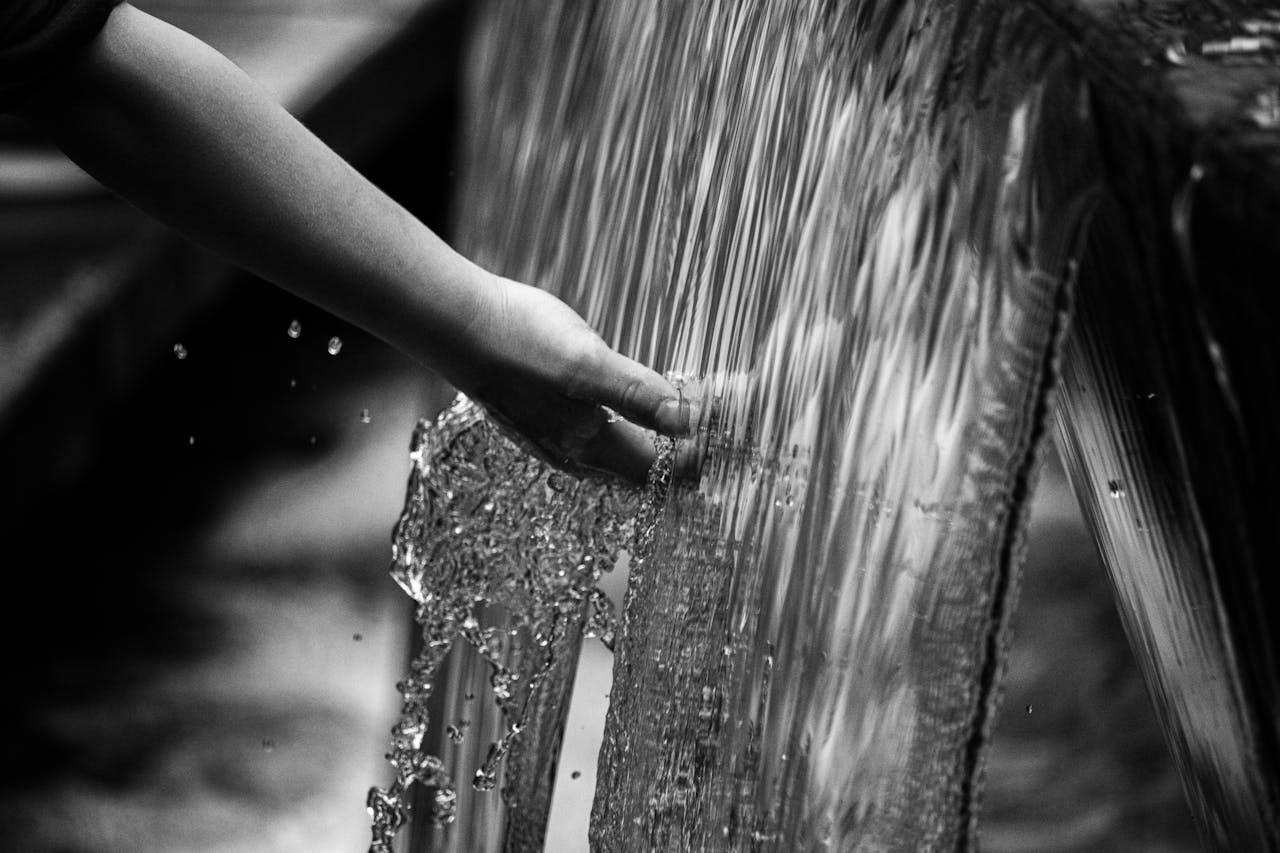 Photo by Tony Mucci: https://www.pexels.com/photo/grayscale-photo-of-persons-hand-on-water-5367191/