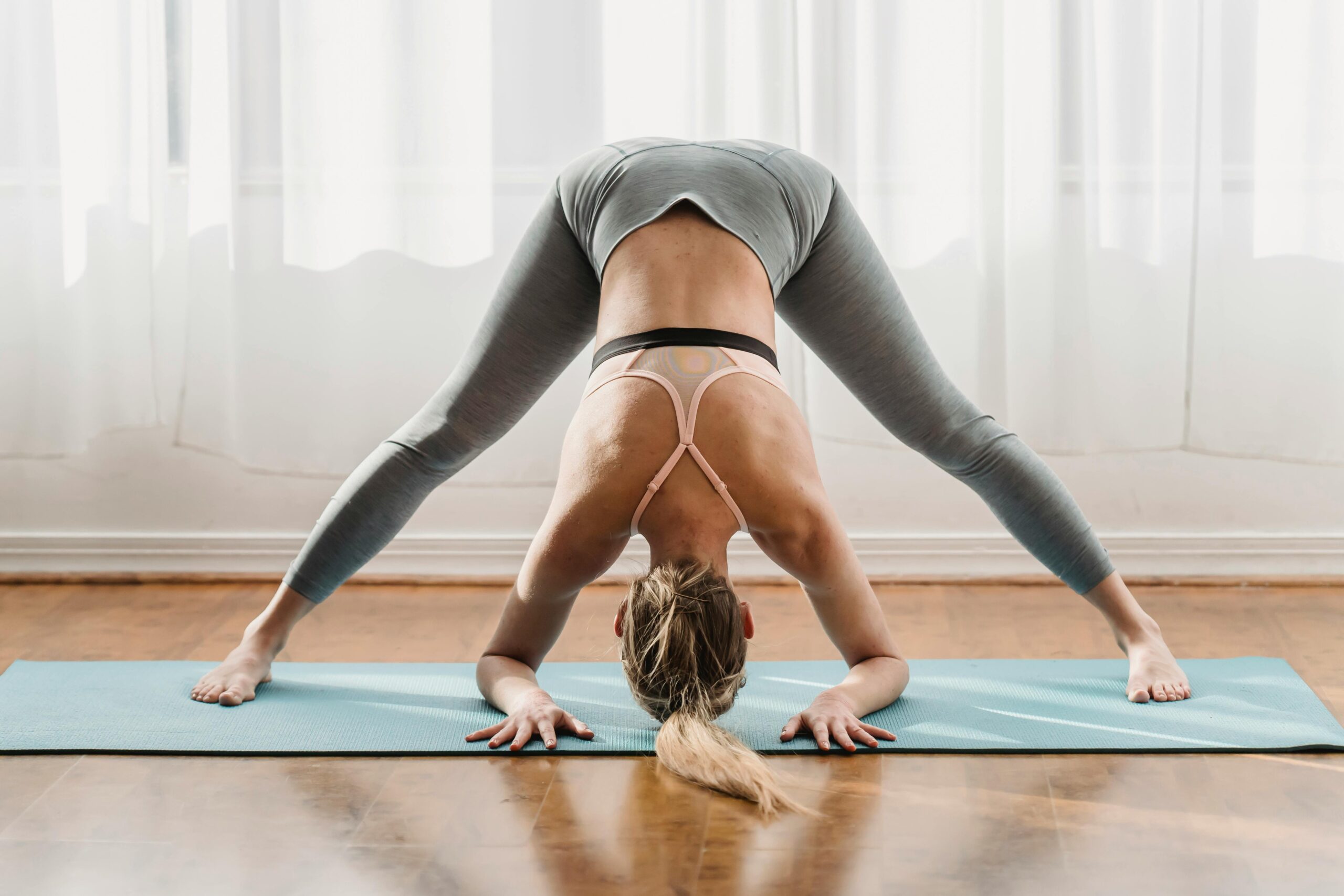 Photo by Marta Wave: https://www.pexels.com/photo/slim-woman-doing-yoga-in-wide-legged-forward-bend-pose-6454068/