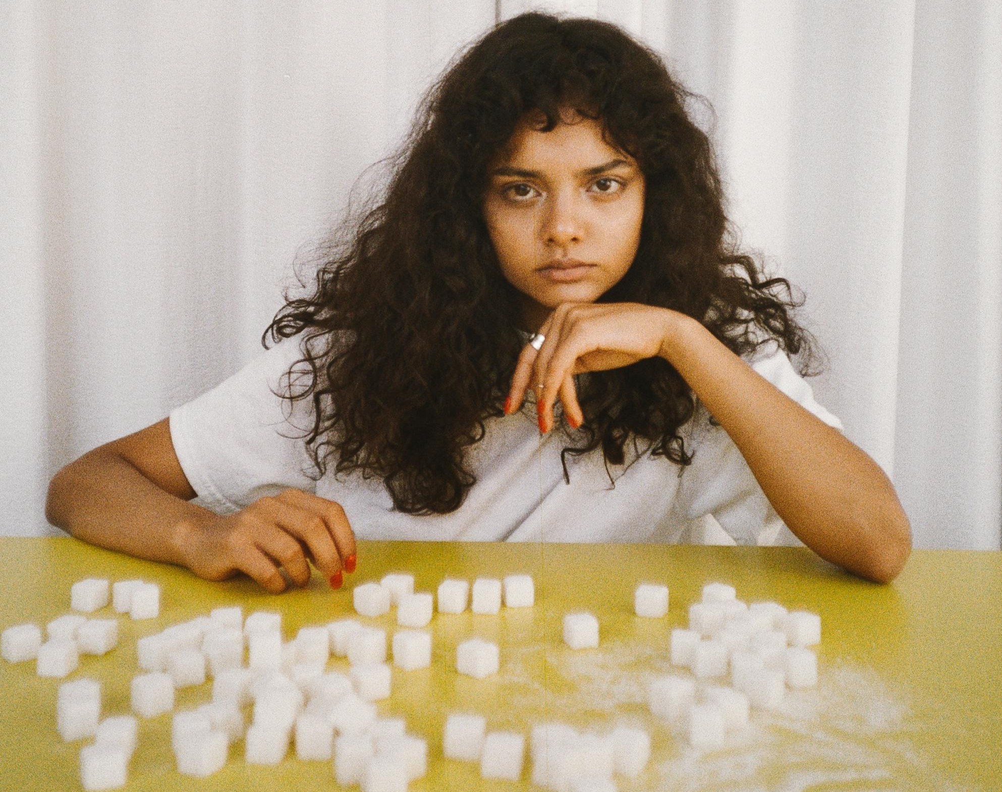 Photo by Polina Tankilevitch: https://www.pexels.com/photo/woman-leaning-on-a-table-with-sugar-cubes-5469304/