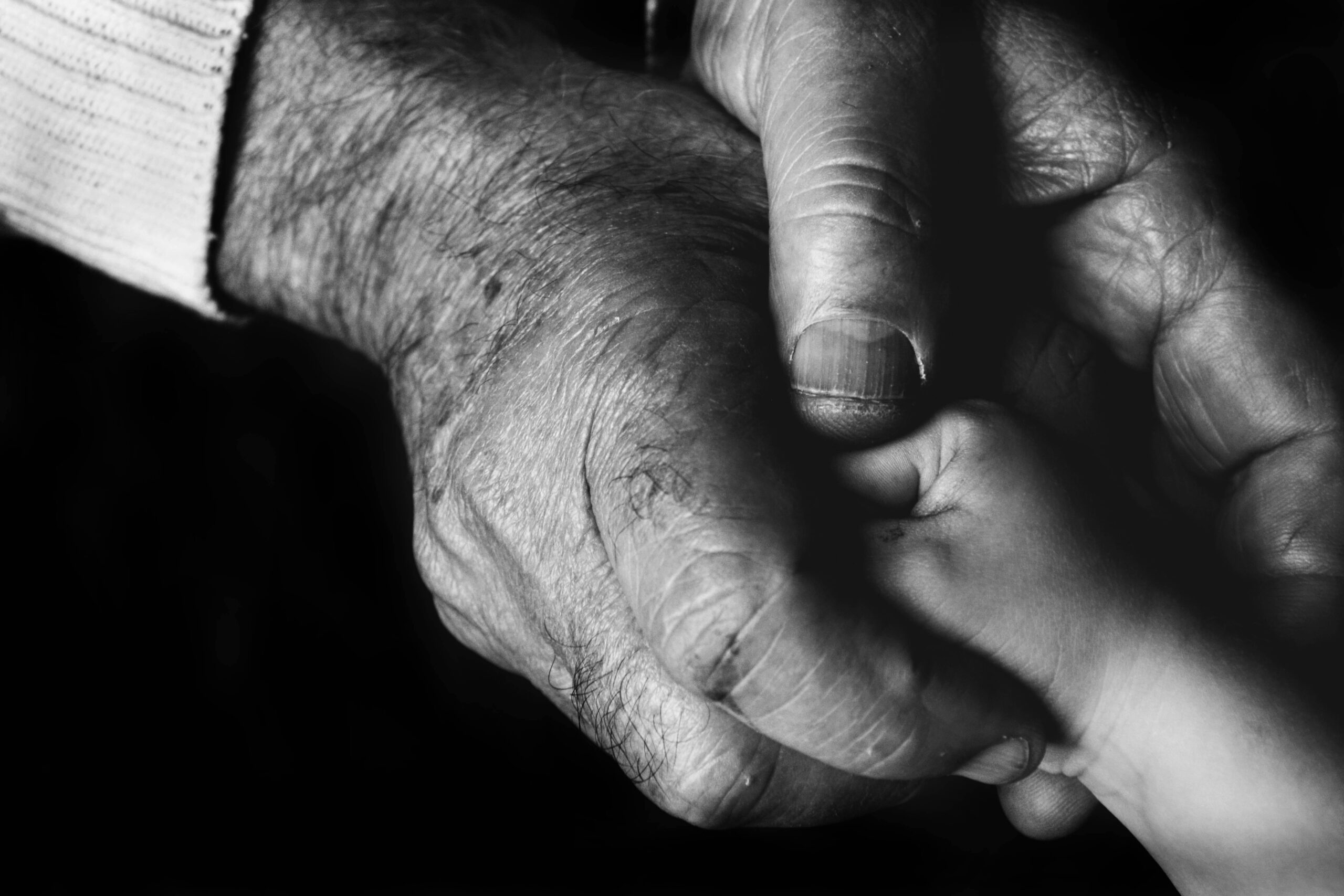 Photo by Danny Doneo: https://www.pexels.com/photo/grayscale-photo-of-an-elderly-person-holding-a-baby-s-hand-10421160/